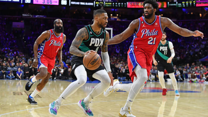 Portland Trail Blazers guard Damian Lillard drives to the basket against Philadelphia 76ers center Joel Embiid.